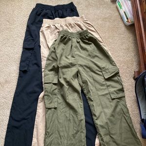 3 pairs of wide leg cargo pants. black, green, and tan.